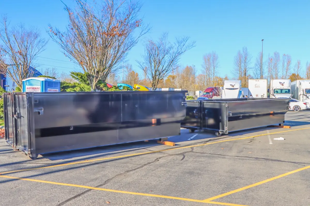 Professional dumpster rental service with roll-off container on residential driveway in Lawton